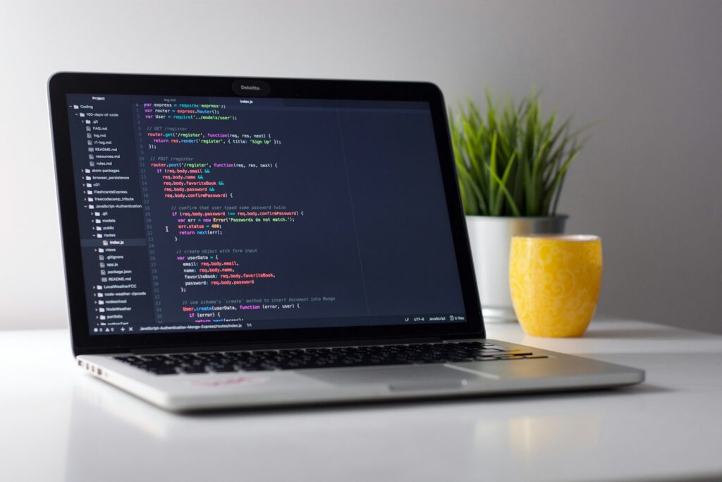 Laptop with code open on a clean workspace