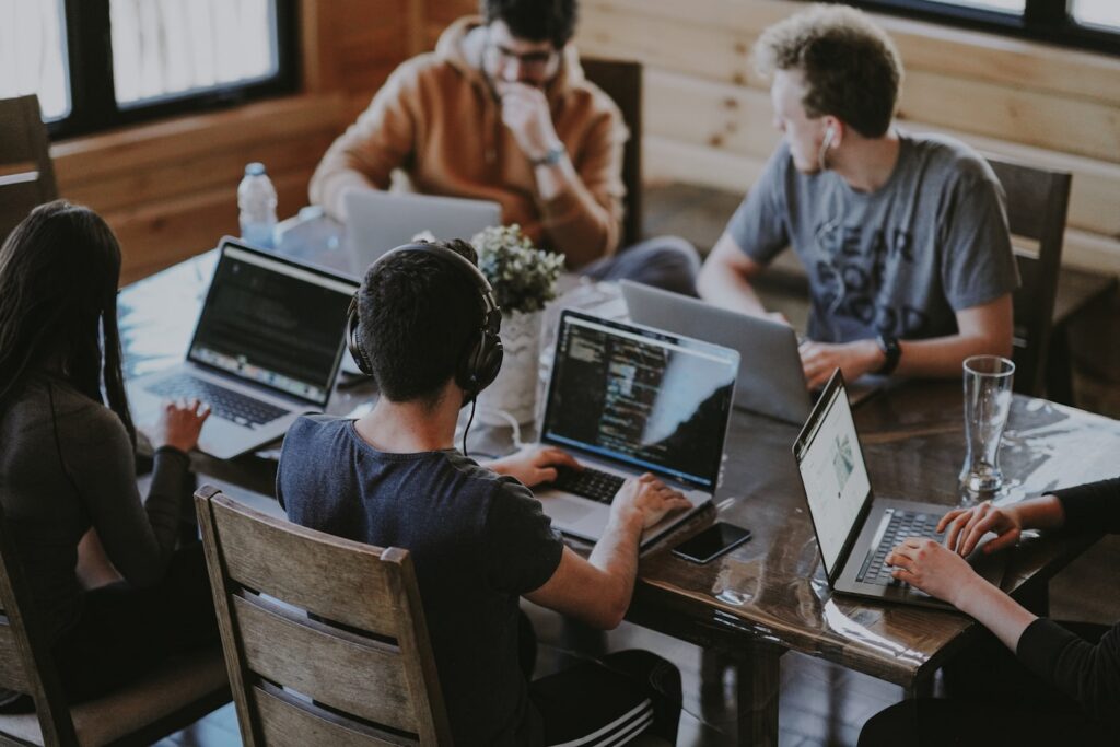 Team of software developers working together on laptops
