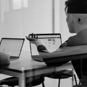 Two people reviewing a website on laptops during a support session